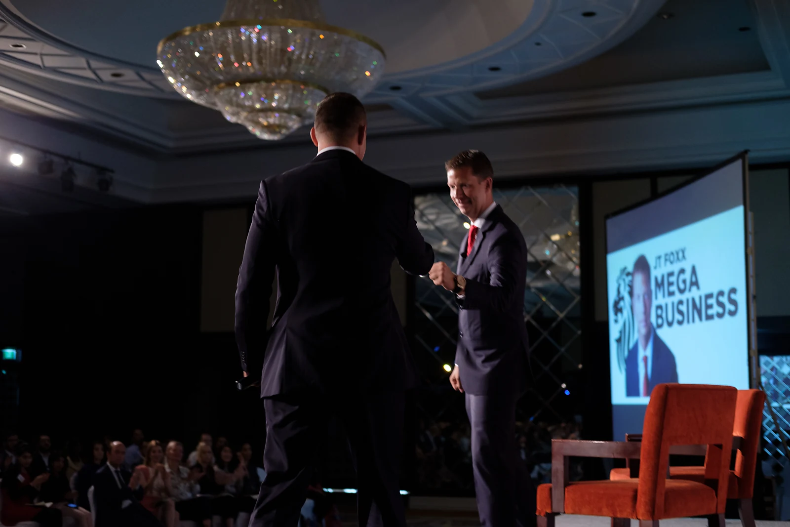 Alexander Erber and JT Foxx exchange a fist bump on stage.